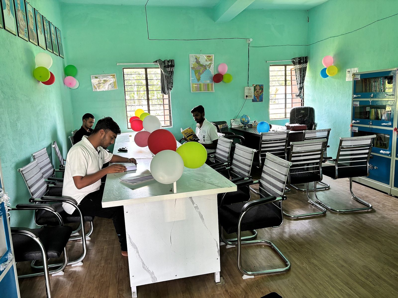 Students studying quietly at a public library reading room.